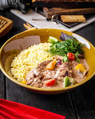 Gourmet dish rice with stewed beef and vegetables