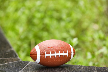 Rugby ball on parapet outdoors