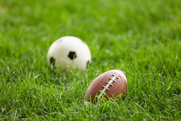 Sports balls on green field