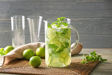 Jug of fresh mojito on table