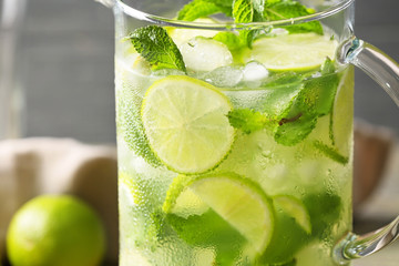 Jug of fresh mojito on table, closeup