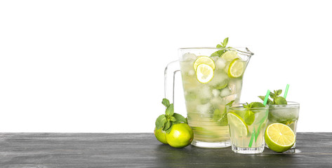 Glassware of fresh mojito on table against white background