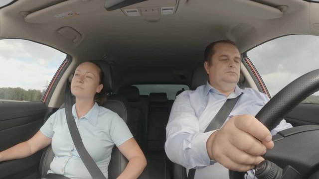 tired man yawns and falls asleep while driving car on highway, frightened woman passenger wakes up sleeping driver. car accident cause concept. emergency situation on road.