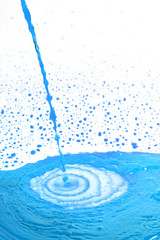 pouring blue cocktail on white background