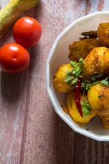 Different view of dum aloo or cooked potatoes Indian style on a background