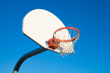 Basketball hoop on blue sky background