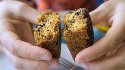 Hands breaking healthy organic vegan bar in half.