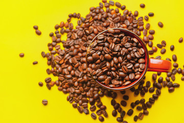 Cup with coffee beans on color background