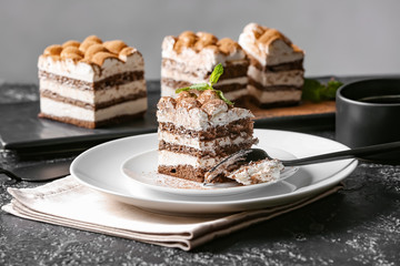 Plate with tasty tiramisu on table
