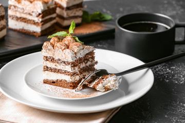Plate with tasty tiramisu on table