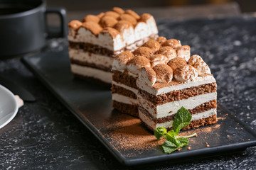 Plate with tasty tiramisu on table