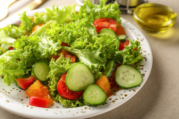 Plate with tasty cucumber salad on table, closeup