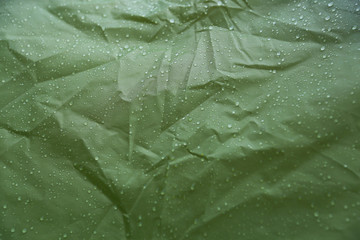 Water drops on the fabric. Rain Water droplets on green fiber waterproof fabric. Water drops...