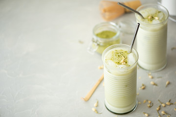 cold green matcha with milk in a tall glass