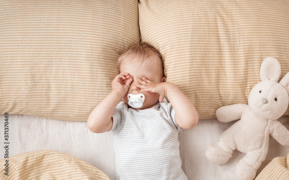 Wall mural one year old baby in the bed