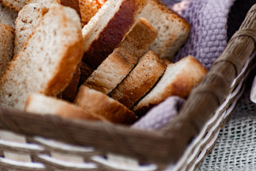 Vanilla crackers for tea, simple sweet crunchy snack in a wicker basket on natural fabric, picnic in nature