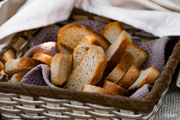 Vanilla crackers for tea, simple sweet crunchy snack in a wicker basket on natural fabric, picnic in nature