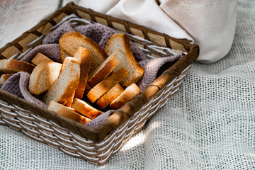 Vanilla crackers for tea, simple sweet crunchy snack in a wicker basket on natural fabric, picnic in nature