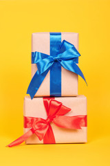 Gift box with ribbon, surprise and present. Isolated on yellow background.