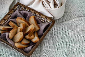 Vanilla crackers for tea, simple sweet crunchy snack in a wicker basket on natural fabric, picnic in nature