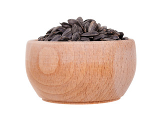 Sunflower seed in wooden jar, isolated on white background.