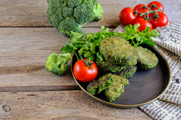  Fried vegetarian patties on a plate with the tomatoes. Healthy vegetarian or vegan food. On a wooden table.