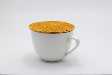 syrub Stroopwafel dessert on hot coffee drink on white isolated