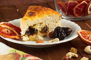 Cottage cheese baked pudding, dried fruits and nuts in a rustic style. Eco-friendly, tasty, healthy food.