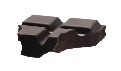 Piece of delicious dark chocolate isolated on white