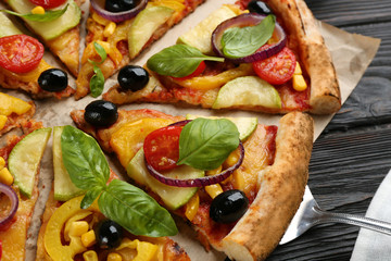 Delicious vegetable pizza on black wooden table, closeup