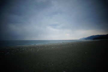 Overcast sky with dark cloud and sea in windy day.