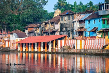 27.12.2019 Gokarna, Karnataka, Colorful indian houses, bright orange-striped temple tank on the bank of sacred lake Koti Teertha. The city is a holy pilgrimage site for Hinduists