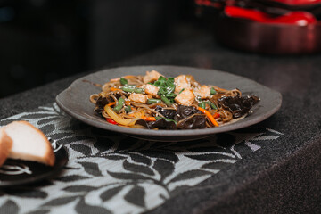 beautiful top view of ready-made dish in a restaurant healthy ingredients fish tuna tomato greens sesame seeds noodles traditional asian cuisine