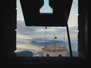 San Marino lansdcape framed in a Guaita tower window. Beautiful landscape from an ancient medieval tower.