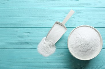 Baking soda on blue wooden table, flat lay