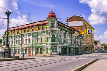 Naklejka premium Kharkiv, Ukraine - July 20, 2020: Former House of engineer P.I. Ivanov on 1 Poltavskiy shlyakh street in Kharkov. Old green neo-baroque building on a city street with modern cars on a sunny summer day