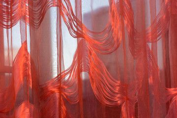 A picture of a curtain with a red light filter