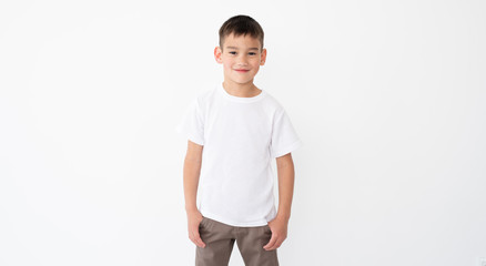Cute little boy wearing blank white t shirt on a white background © Ievgen Skrypko