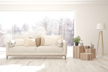 Fototapeta premium White stylish minimalist room with sofa and winter landscape in window. Scandinavian interior design. 3D illustration