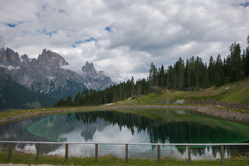 Fototapeta na wymiar Idyllic lake near San Martino di Castrozza with Pale di San Martino in the background on summer day, Trentino