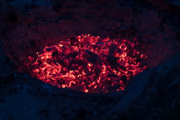 red-hot coals in the camp fire - shining in the night