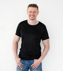Fototapeta premium Attractive young man in a black T-shirt. Blank for your design