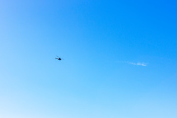 A helicopter flying in the clear blue sky