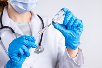 Doctor holding syringe, medical injection in hand with glove