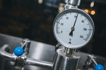 Modern equipment in modern beer factory. Fermentation in brewery tanks with beer for brewing. Big steel tanks for storage.