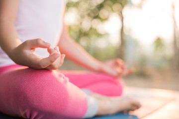 calmness and relax, female happiness.Horizontal, blurred background. little asian girl meditates while practicing yoga. freedom concept. calmness and relax, child happiness. toned picture healthy life