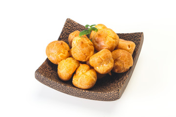 Sweet tasty profiteroles heap in the bowl