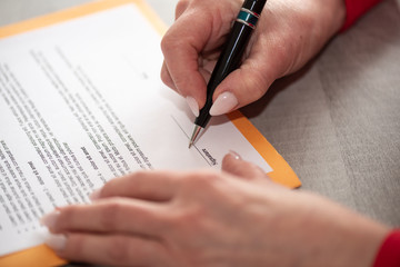 Hand of businesswoman signing a document