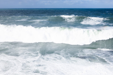 Foamy stong waves crashing in the ocean