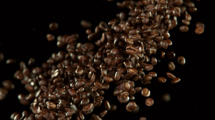 Coffee beans flying in the air in freeze motion